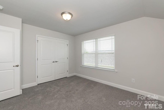 unfurnished bedroom featuring baseboards, a closet, and carpet flooring