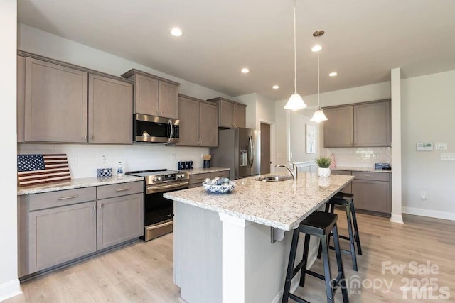 1479 Mocksville Hwy Unit 23, Statesville, NC 28625 - kitchen with appliances with stainless steel finishes, a sink, light wood finished floors, a center island with sink, and recessed lighting