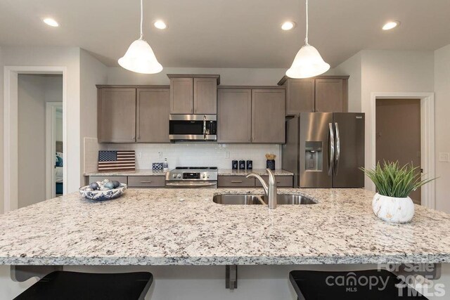 1479 Mocksville Hwy Unit 23, Statesville, NC 28625 - kitchen featuring stainless steel appliances, a sink, a kitchen breakfast bar, tasteful backsplash, and a large island