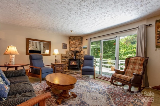 597 Sweetwater Rdg, Burnsville, NC 28714 - living room with a wood stove, a textured ceiling, and wood finished floors