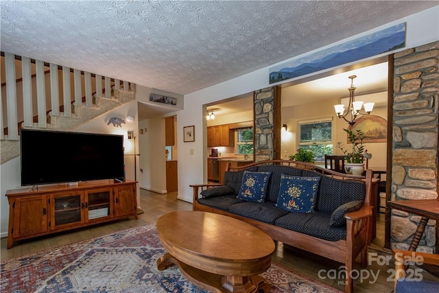 597 Sweetwater Rdg, Burnsville, NC 28714 - living area with a textured ceiling, wood finished floors, a chandelier, and stairs