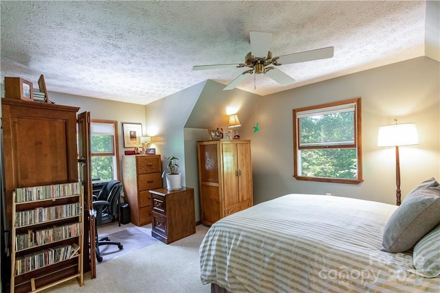 597 Sweetwater Rdg, Burnsville, NC 28714 - bedroom with light colored carpet, vaulted ceiling, a textured ceiling, and a ceiling fan