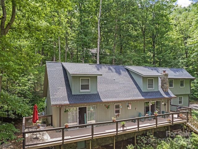 597 Sweetwater Rdg, Burnsville, NC 28714 - view of front of home with a deck, roof with shingles, and a wooded view