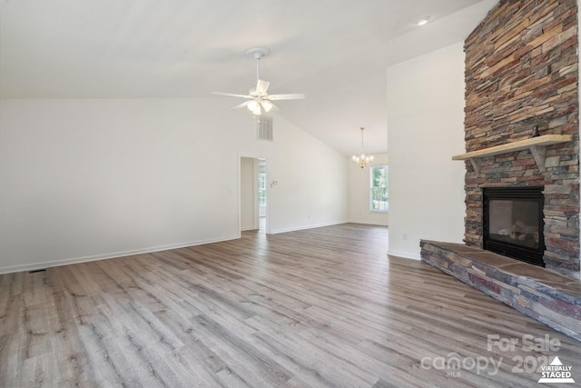 260 Treebark Rd, Statesville, NC 28625 - unfurnished living room featuring a stone fireplace, wood finished floors, a chandelier, ceiling fan, and baseboards