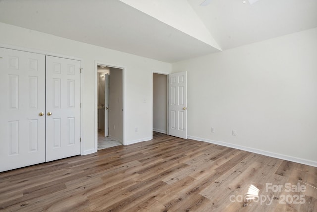 260 Treebark Rd, Statesville, NC 28625 - unfurnished bedroom with wood finished floors, a closet, baseboards, vaulted ceiling, and ensuite bathroom