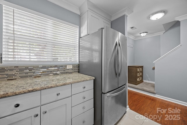 3736 Melrose Cottage Dr, Matthews, NC 28105 - kitchen featuring baseboards, freestanding refrigerator, white cabinets, and ornamental molding