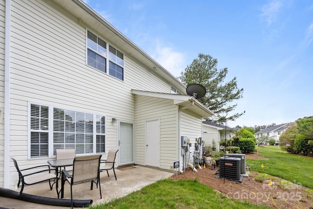 3736 Melrose Cottage Dr, Matthews, NC 28105 - back of property featuring central air condition unit, a patio, and a yard