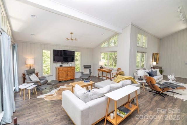living area featuring lofted ceiling with beams and wood finished floors