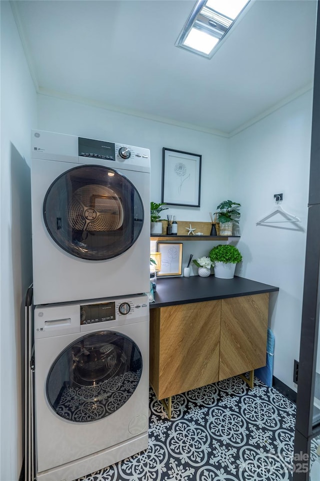 laundry room featuring stacked washer and dryer, crown molding, tile patterned flooring, and laundry area