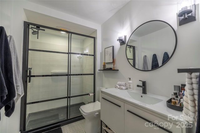 bathroom featuring vanity, toilet, and a stall shower
