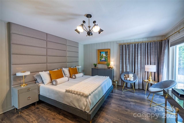 bedroom with wood finished floors and a chandelier