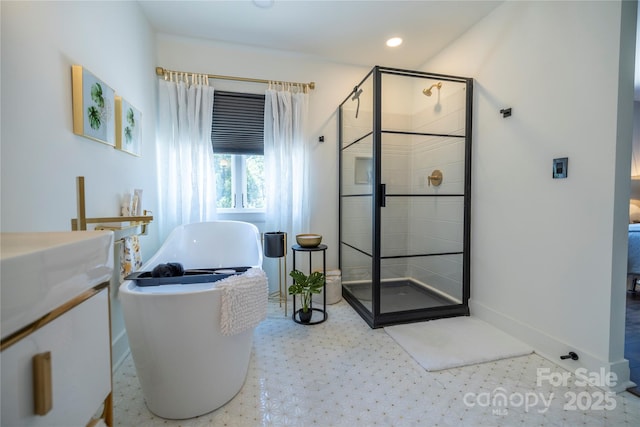 full bathroom with recessed lighting, tile patterned floors, a stall shower, baseboards, and a soaking tub