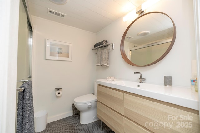 bathroom featuring a shower with shower door, tile patterned flooring, toilet, vanity, and visible vents