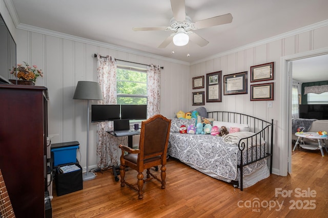 bedroom featuring crown molding, ceiling fan, baseboards, and wood finished floors