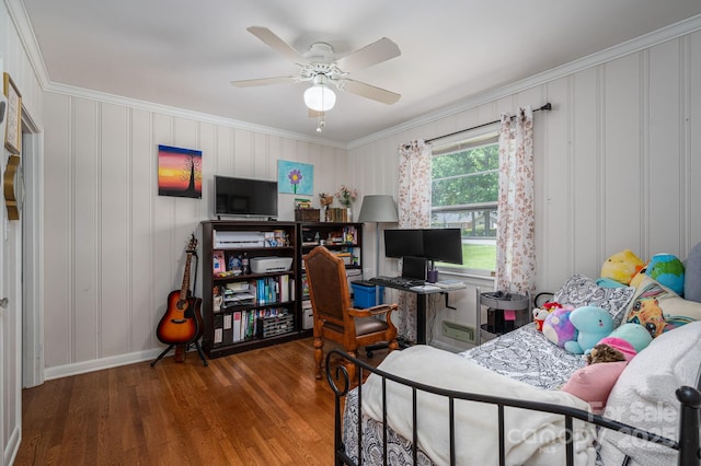 bedroom featuring crown molding, baseboards, a ceiling fan, and wood finished floors