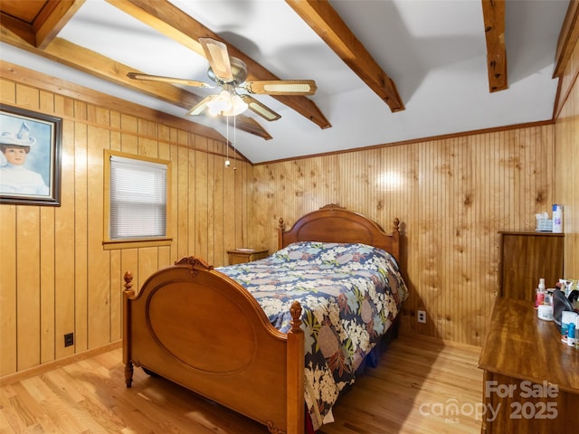 bedroom with wood walls and wood finished floors