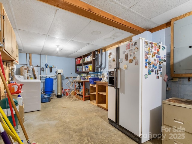 interior space with washer / dryer, white fridge with ice dispenser, electric panel, and a paneled ceiling