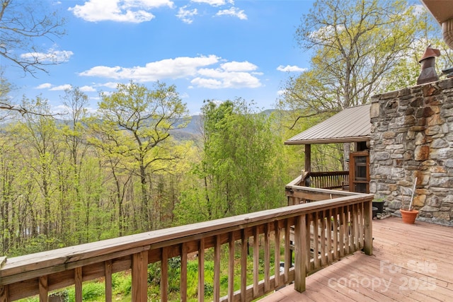 wooden deck featuring a view of trees