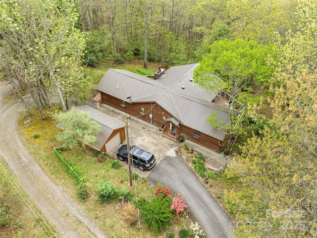 drone / aerial view with a wooded view