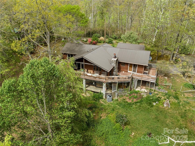 birds eye view of property with a forest view