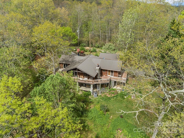 birds eye view of property with a wooded view
