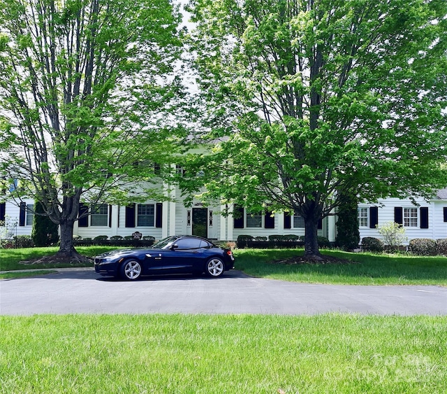 obstructed view of property with a front yard
