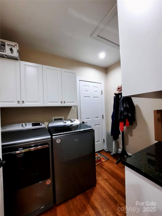 laundry room with recessed lighting, cabinet space, radiator, washer and clothes dryer, and dark wood-type flooring