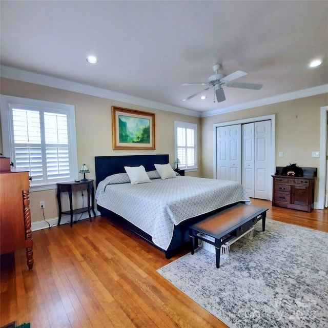 bedroom featuring recessed lighting, wood finished floors, a closet, baseboards, and crown molding