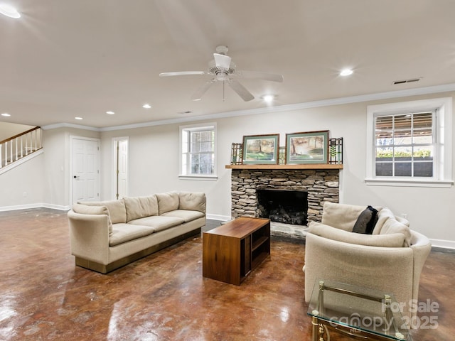 living room featuring a fireplace, a ceiling fan, concrete flooring, and baseboards