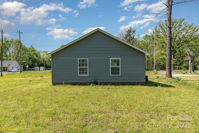 view of side of property with a yard