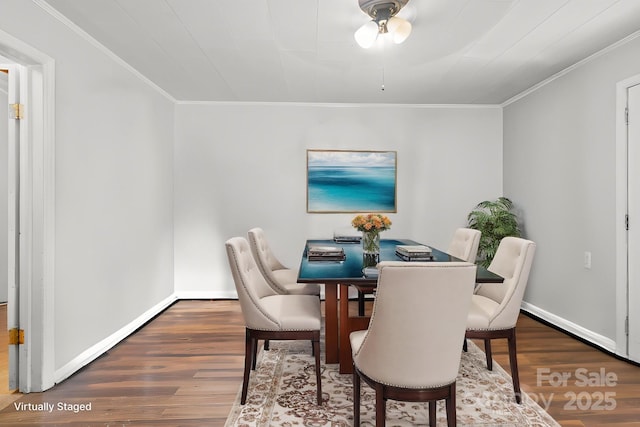dining area with baseboards, wood finished floors, a ceiling fan, and ornamental molding