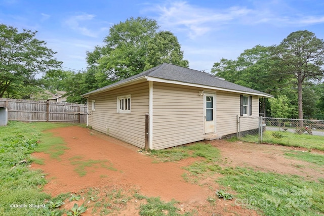 view of side of home with a fenced backyard