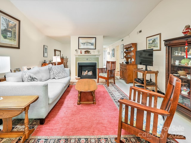 living room with a fireplace, visible vents, and lofted ceiling