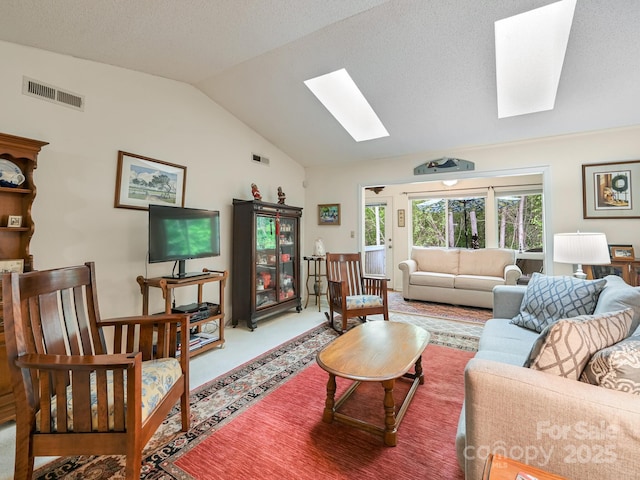 carpeted living area featuring lofted ceiling with skylight, visible vents, and a healthy amount of sunlight