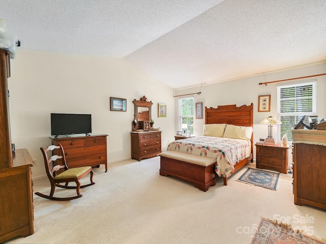 bedroom featuring a textured ceiling, vaulted ceiling, and carpet