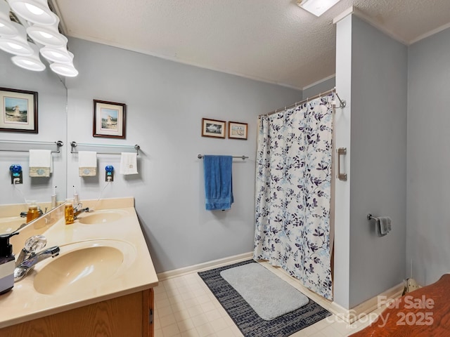 bathroom with double vanity, baseboards, a shower with curtain, and a sink
