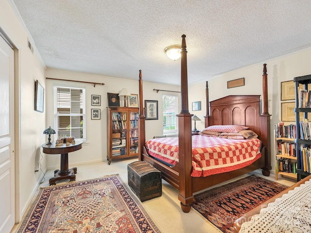 carpeted bedroom featuring a textured ceiling and visible vents