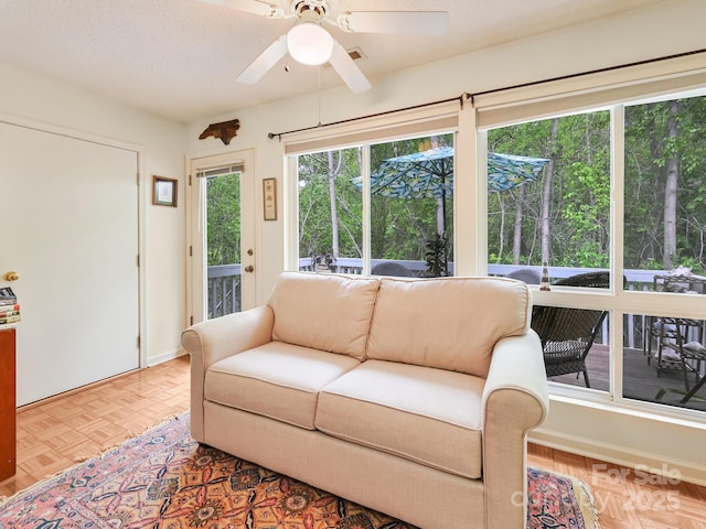 interior space with outdoor lounge area and ceiling fan