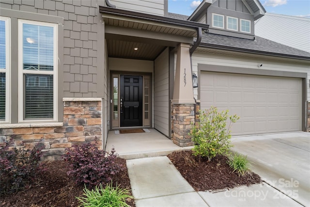 1287 Fishing Creek Rd, Lake Wylie, SC 29710 - view of exterior entry with stone siding, driveway, and roof with shingles