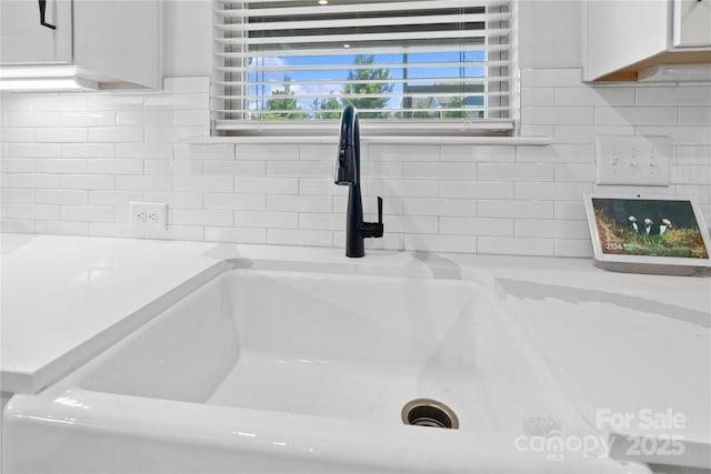 1287 Fishing Creek Rd, Lake Wylie, SC 29710 - kitchen view of a sink, light countertops, decorative backsplash, and white cabinets