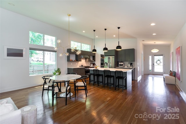 dining space featuring recessed lighting, baseboards, and dark wood-style flooring