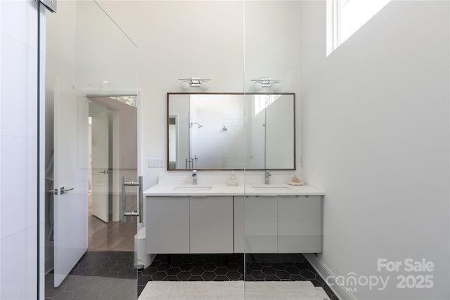 bathroom featuring double vanity, a sink, and tile patterned flooring