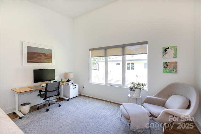 home office featuring baseboards and wood finished floors