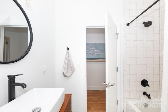 full bathroom with vanity, baseboards, wood finished floors, and bathtub / shower combination