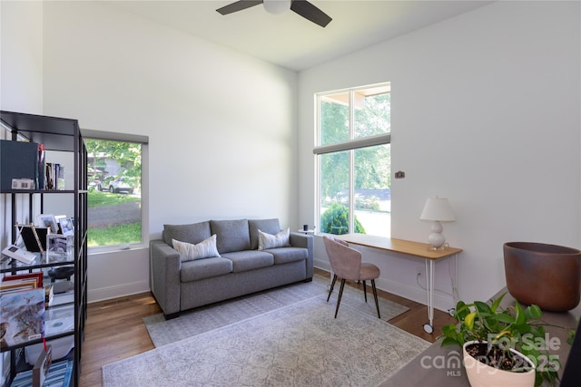 office area featuring baseboards, ceiling fan, and wood finished floors