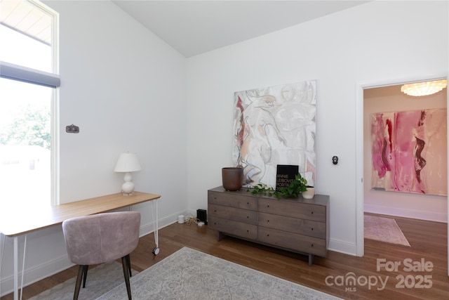 office area with baseboards, vaulted ceiling, and wood finished floors