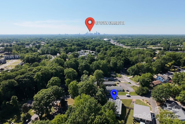 drone / aerial view with a wooded view