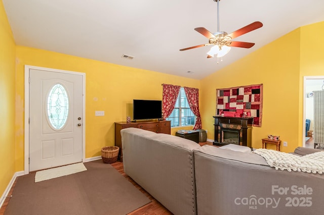 814 Independence Dr, Wingate, NC 28174 - living area featuring a ceiling fan, baseboards, vaulted ceiling, and a glass covered fireplace