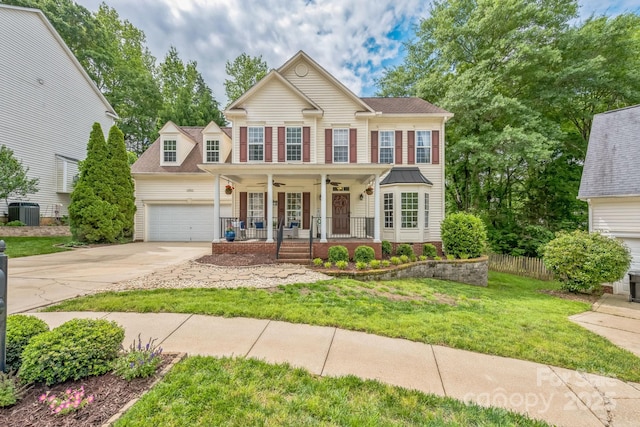 13312 Edgetree Dr, Pineville, NC 28134 - view of front of home featuring ceiling fan, a porch, a front yard, concrete driveway, and central air condition unit