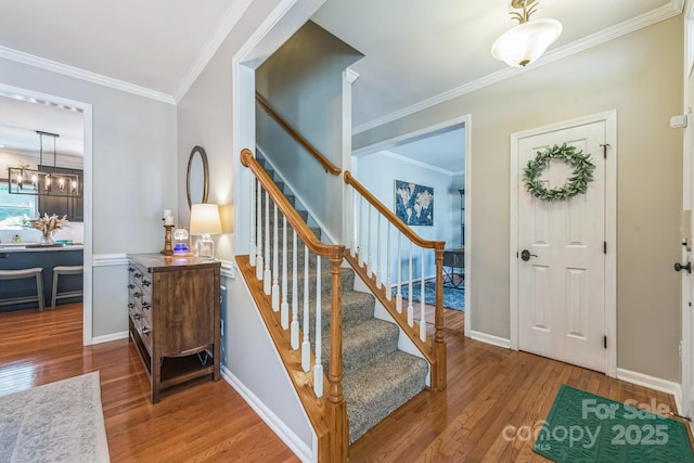 13312 Edgetree Dr, Pineville, NC 28134 - staircase featuring baseboards, ornamental molding, wood finished floors, and a notable chandelier